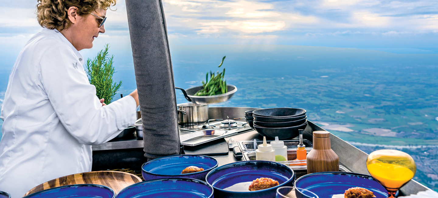 Photo of a chef cooking a meal on a boat at sea