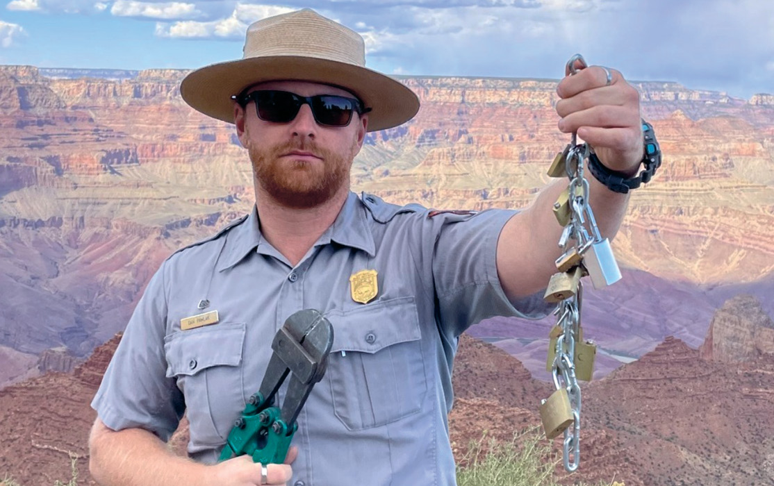 Photo of a Grand Canyon Park Ranger holding a chain of locks he cut off