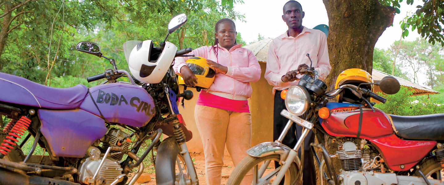 Image of two people standing in front of their motorcycles