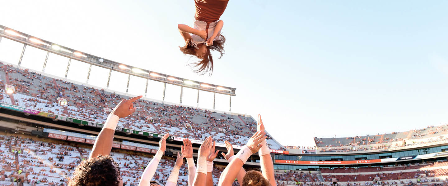 Image of a cheerleader flipping in the air