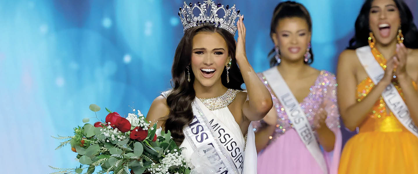 a beauty pageant winner holding her crown